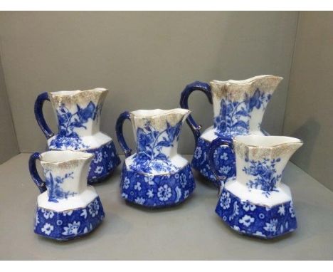 A set of five blue and white graduating jugs marked 'Alton K and Co.' to the base. 