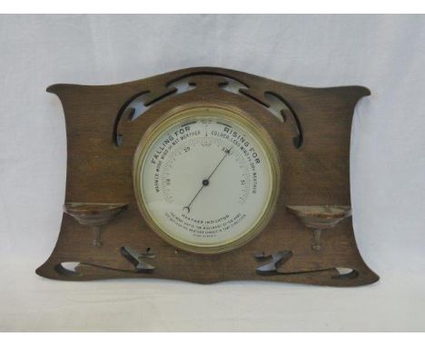 An Art Nouveau oak wall mounted barometer. 