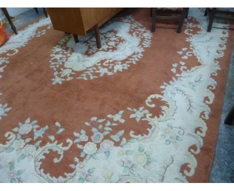 A large room size Oriental floor rug, the central medallion on a rust ground, 112 x 146".
