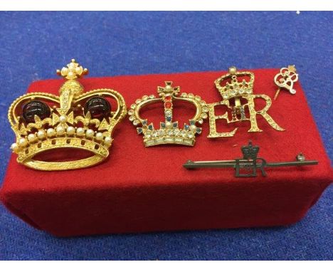 A silver Elizabeth II bar brooch, an Elizabeth II stick pin and three highly decorative coronet brooches. 