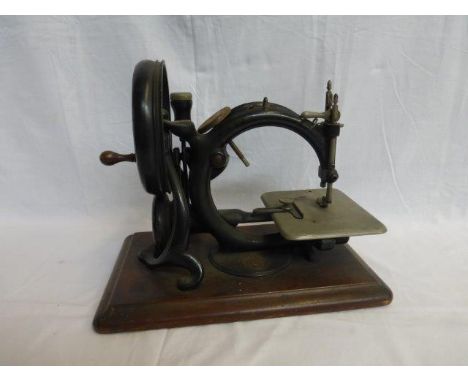 A Willcox & Gibbs sewing machine stamped Jas. Steel & Co, Cheltenham, with medallion attached, set on mahogany base. 
