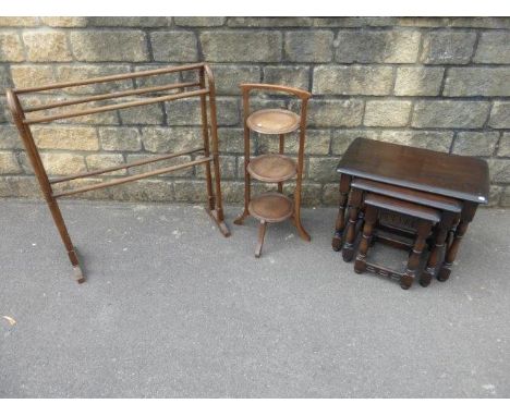 A three tier cake stand, a towel rail and a nest of three Ercol style tables. 