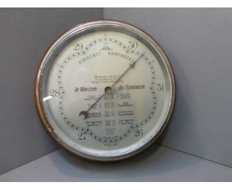 An oak cased circular barometer: 'The Wilson'.
