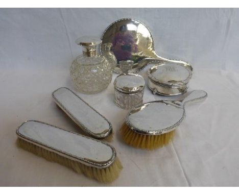 A silver four piece dressing table set, a silver topped cut glass scent bottle, a silver topped cut glass jar and a silver tr