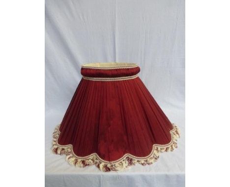 A ruby silk standard lampshade. 