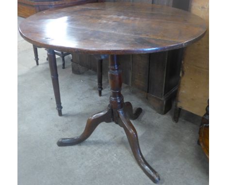 A George III oak circular tilt top tripod tea table 