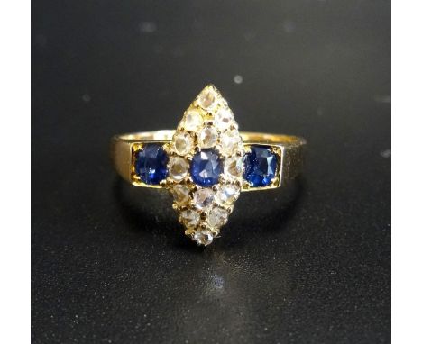 EDWARDIAN SAPPHIRE AND DIAMOND DRESS RINGthe central oval cut sapphire in marquise shaped diamond surround, flanked by sapphi