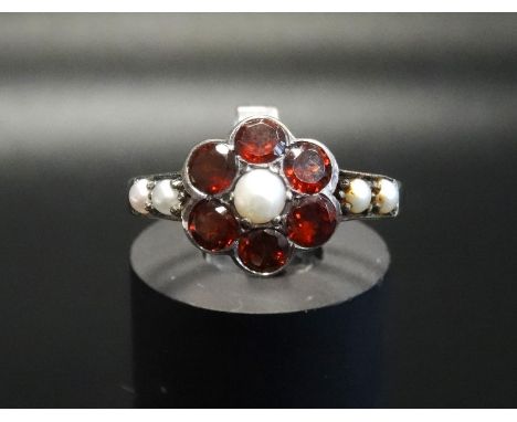 GARNET AND PEARL CLUSTER RINGon unmarked gold shank with silver setting, ring size N 