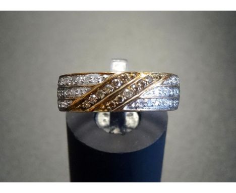 PAVE SET WHITE AND YELLOW DIAMOND RINGthe three rows of white diamonds with central diagonal double row of yellow diamonds, o