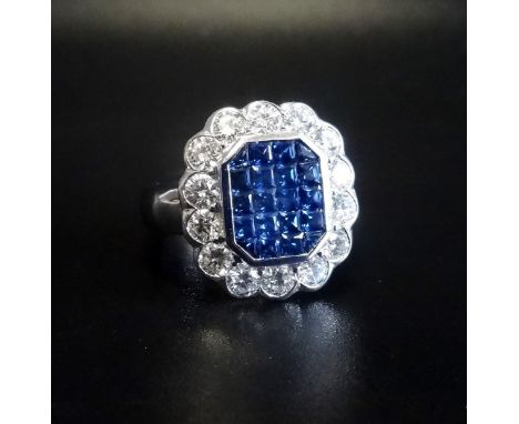 IMPRESSIVE SAPPHIRE AND DIAMOND CLUSTER DRESS RINGthe central cluster of princess cut sapphires totalling approximately 0.9ct