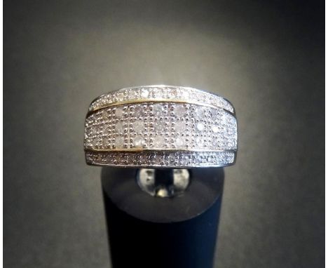 MULTI DIAMOND DRESS RINGthe central three raised rows of diamonds with a further row above and below, in all approximately 0.