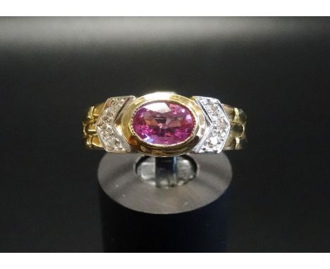 PINK TOPAZ AND DIAMOND DRESS RINGthe central bezel set oval cut topaz flanked by three diamonds to each side, on nine carat g