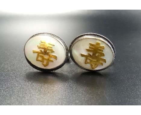 PAIR OF HONG KONG STERLING SILVER CUFFLINKSthe oval tops with mother of pearl and applied character marks (these possibly gol