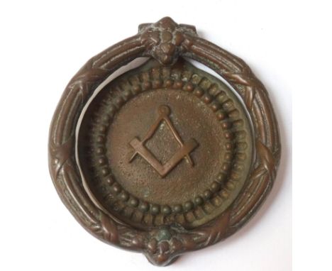 MASONIC BRASS DOOR KNOCKERwith a circular banded handle, the circular knocker back plate with the set square and compass, 14c