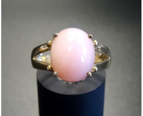 PERUVIAN PINK OPAL DRESS RINGthe oval cabochon opal on nine carat gold shank with decorative split shoulders, ring size N, to