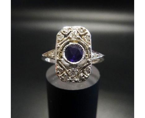 ART DECO STYLE AMETHYST AND DIAMOND PLAQUE RINGthe central round cut amethyst in pierced deiamond set surround, in nine carat