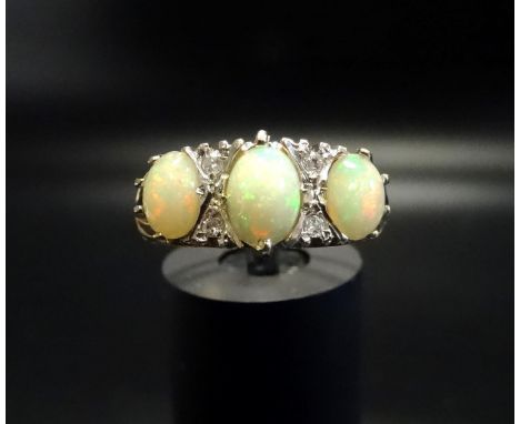 OPAL AND DIAMOND RINGthe three oval cabochon opals separated by small diamonds, on nine carat gold shank, ring size R-S 