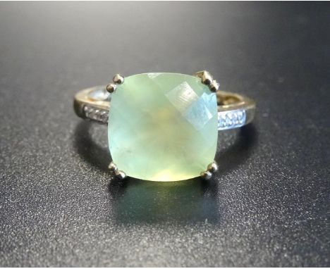 UNUSUAL APATITE AND DIAMOND DRESS RINGthe central cushion briolette cut apatite flanked by diamond set shoulders, on nine car