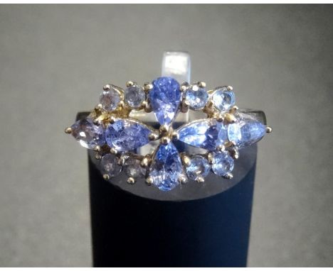 TANZANITE CLUSTER RINGthe pear and round cut tanzanites in pierced setting, on nine carat gold shank, ring size N 