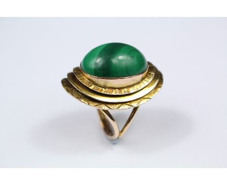 A 9ct Yellow Gold and Malachite Dress Ring. The malachite stone measures approx 32 x 22mm, size N, approx 13.4 gms, mm ELC.