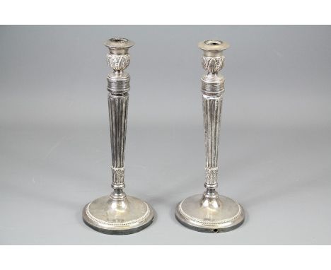 A Pair of Heavy Candle Stick Holders; the candle sticks approx 33 cms h.&nbsp;