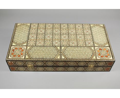A Syrian Marquetry Backgammon Box. The hinged cover opens to reveal a playing board, counters and dice, approx 50 w x 25.5 l 