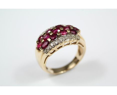 A Lady's 14ct Yellow Gold, Ruby and Diamond Dress Ring, the ring set with thirteen oval-cut rubies, 3 x 2 mm, set within a bo