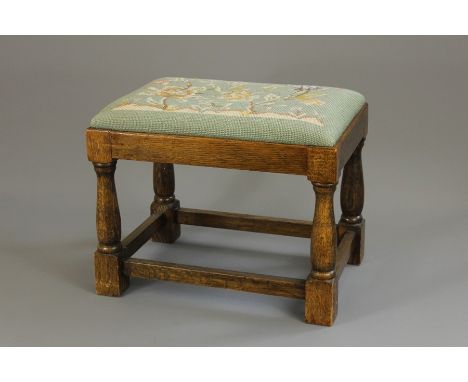 A Victorian Footstool, with tapestry turquoise-coloured floral design, turned legs with stretchers, approx 43 x 30 x 34 cms.