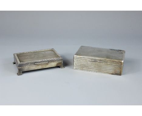 Two Silver Cigarette Boxes. The first an engine-turned box London hallmark, dated 1913, mm T.E &amp; Co together with another