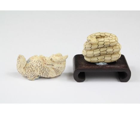 A Chinese Ivory Netsuke of a Coiled Serpent, approx 3 x 3.8 cms, mounted on a hard-wood stand together with another netsuke o