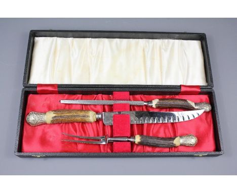 An Antler Handled Cooper Bros &amp; Sons Ltd Carving Set; comprising carving knife, fork and steel, in the original presentat