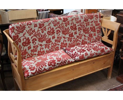 A Pine Kitchen Bench, the bench having a storage area beneath the seat, decorative leaf design to slat back and sides, approx