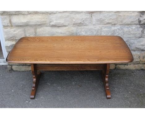 An Ercol Teak Coffee Table; the table having two decorative supports with stretcher, approx 128 x 67 x 51 cms.&nbsp;