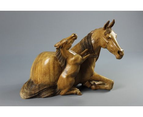 African Matabele Light Wood Carving of a Mare; the resting mare accompanied by her playful, rearing foul, approx 46 x 35 x 28