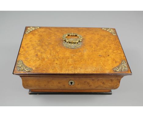 An Early 19th Century Palais Royale Burr Maple Sewing Box/Necessaire; the box having ormolu mounts with ring top handle. The 