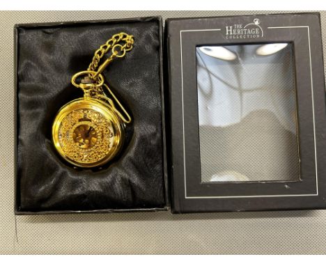 Gold coloured manual wind pocket watch on chain with partial white dial & exhibition back 