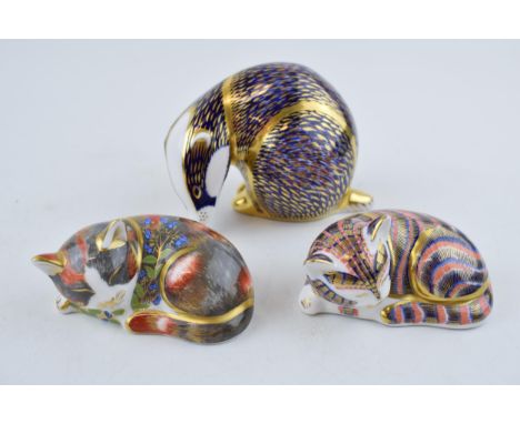 Royal Crown Derby paperweights to include a badger, a catnip kitten, both first quality with stoppers and a similar kitten, s