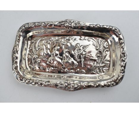 Hallmarked silver heavily embossed pin tray with a romantical scene of a gentleman playing music for a pair of ladies, 32.2 g