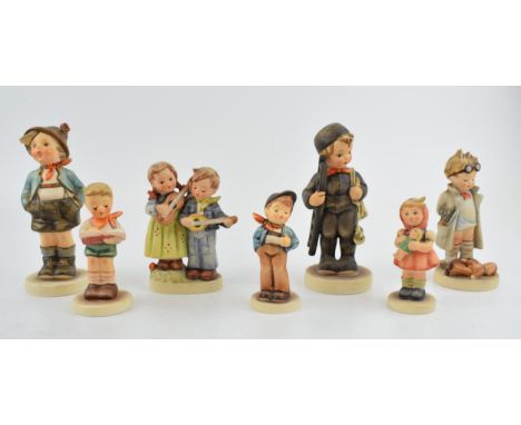 A collection of Goebel and Hummel child figures to include a girl with a doll, a boy with ladders, a Doctor, Honor Student, c