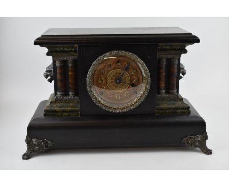 Faux slate Victorian mantle clock with chiming movement. Lion's head garnitures with columns. 45cm x 29cm.  In good cosmetic 