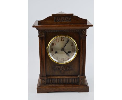 A vintage chiming mantle clock in dark wood case. Pendulum movement. Height 35cm.  In original condition. Untested.