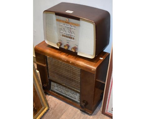 Two vintage valve radios to include a bakelite example and another in a wooden case. (2)  Cosmetically in good vintage order.