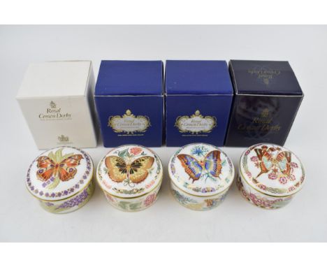 A set of four Royal Crown Derby Butterflies of The World circular trinket pots and covers, comprising, Peacock, Fivebar Sword