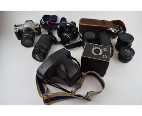 A collection of vintage cameras and lenses to include Olympus OM10, Canon EOS and FinePix cameras together with a collection 