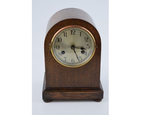 A vintage chiming mantle clock in dark wood case. Pendulum movement. In working order. Height 26cm.  In original vintage cond