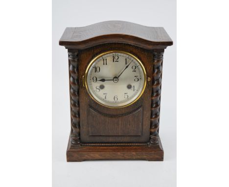 A vintage chiming mantle clock in dark wood case. Pendulum movement. Height 28cm.  In original vintage condition. Untested.