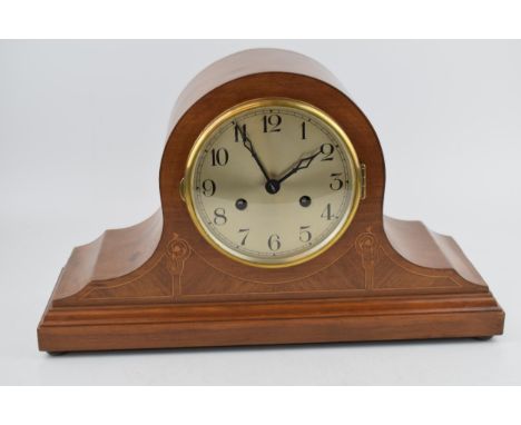 A vintage chiming "Napoleons Hat' shaped mantle clock in satin wood case with inlaid marquetry decoration. Pendulum movement.
