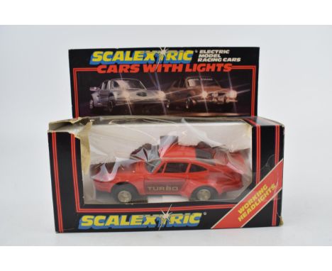 A boxed vintage Scalextric C.427 Red Porsche Turbo with working head and brake lights.  Model in excellent condition. Box has