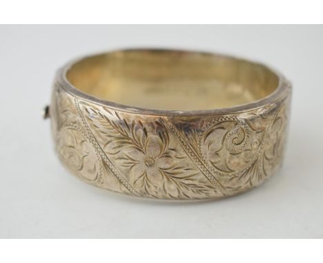 Wide silver bangle with engraved floral decoration, 40.9 grams, 7cm diameter, Birm 1962.  