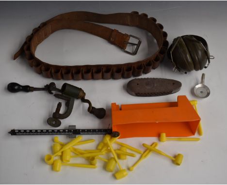 A collection of gun and shooting related items including a leather cartridge belt, ear defenders, 12 bore shotgun cartridge r